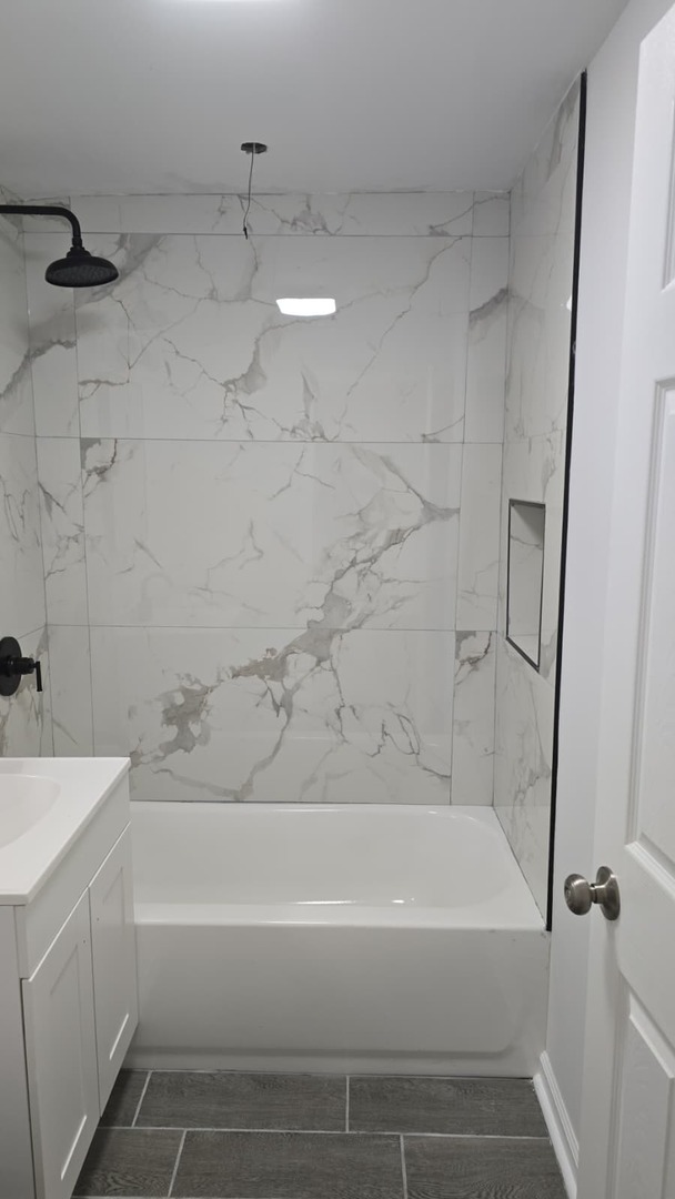 5740 South Elizabeth Street Chicago, IL 60636 - Photo 26 of 45 a bathroom with a bathtub and a shower