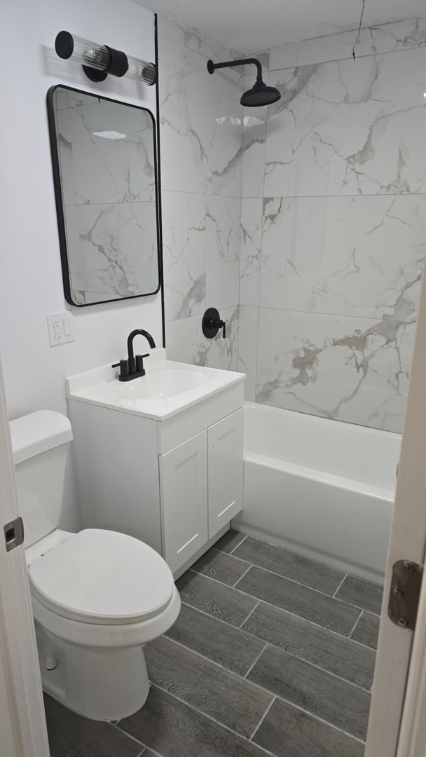 5740 South Elizabeth Street Chicago, IL 60636 - Photo 27 of 45 a bathroom with a sink toilet and shower