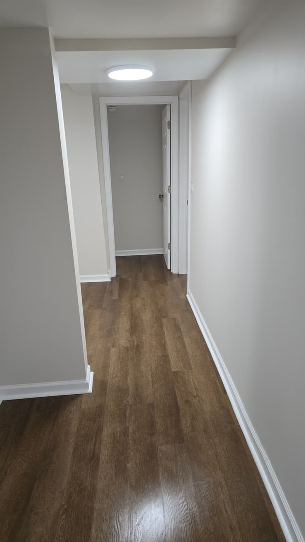 5740 South Elizabeth Street Chicago, IL 60636 - Photo 35 of 45 an empty room with wooden floor and door