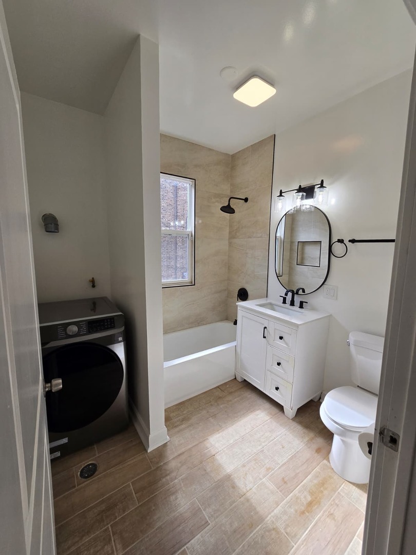5740 South Elizabeth Street Chicago, IL 60636 - Photo 38 of 45 a bathroom with a granite countertop toilet sink and mirror