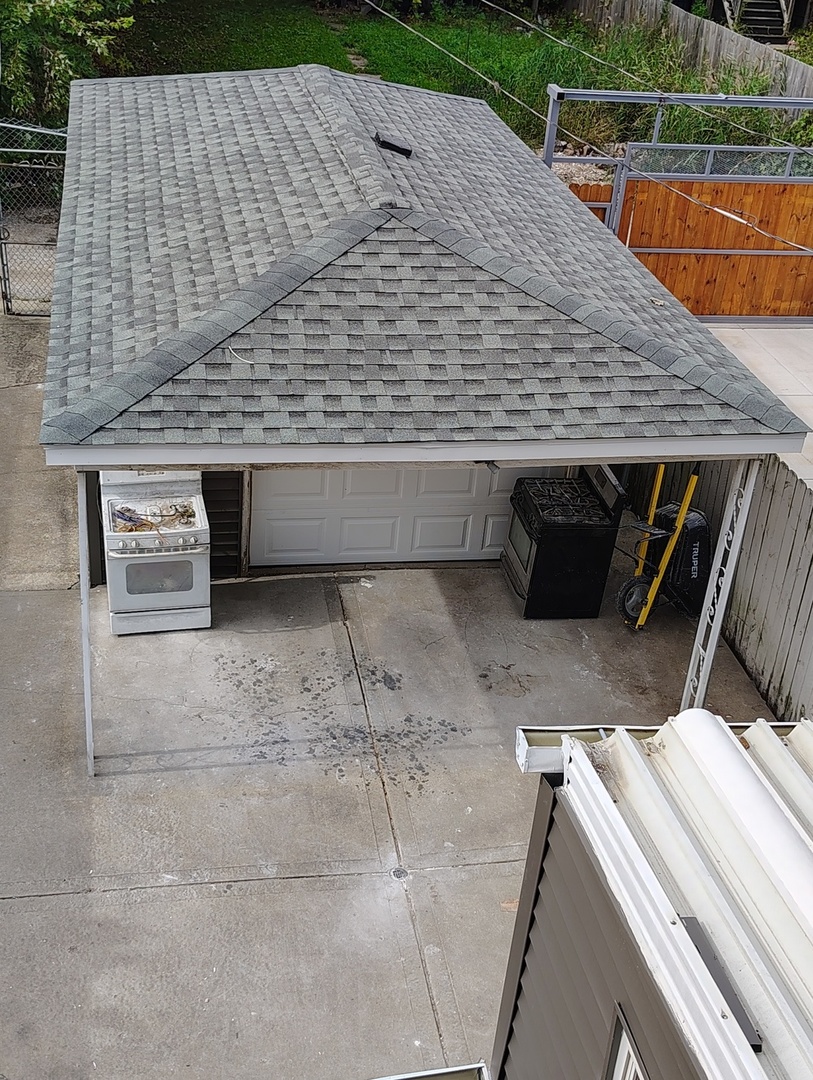 5740 South Elizabeth Street Chicago, IL 60636 - Photo 43 of 45 a roof deck view with a barbeque grill and wooden fence