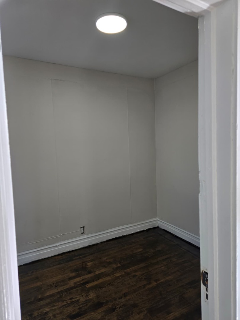 5740 South Elizabeth Street Chicago, IL 60636 - Photo 8 of 45 a view of a small space with wooden floor and a window