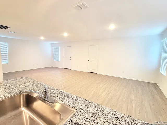 a view of wooden floor and a sink in a room