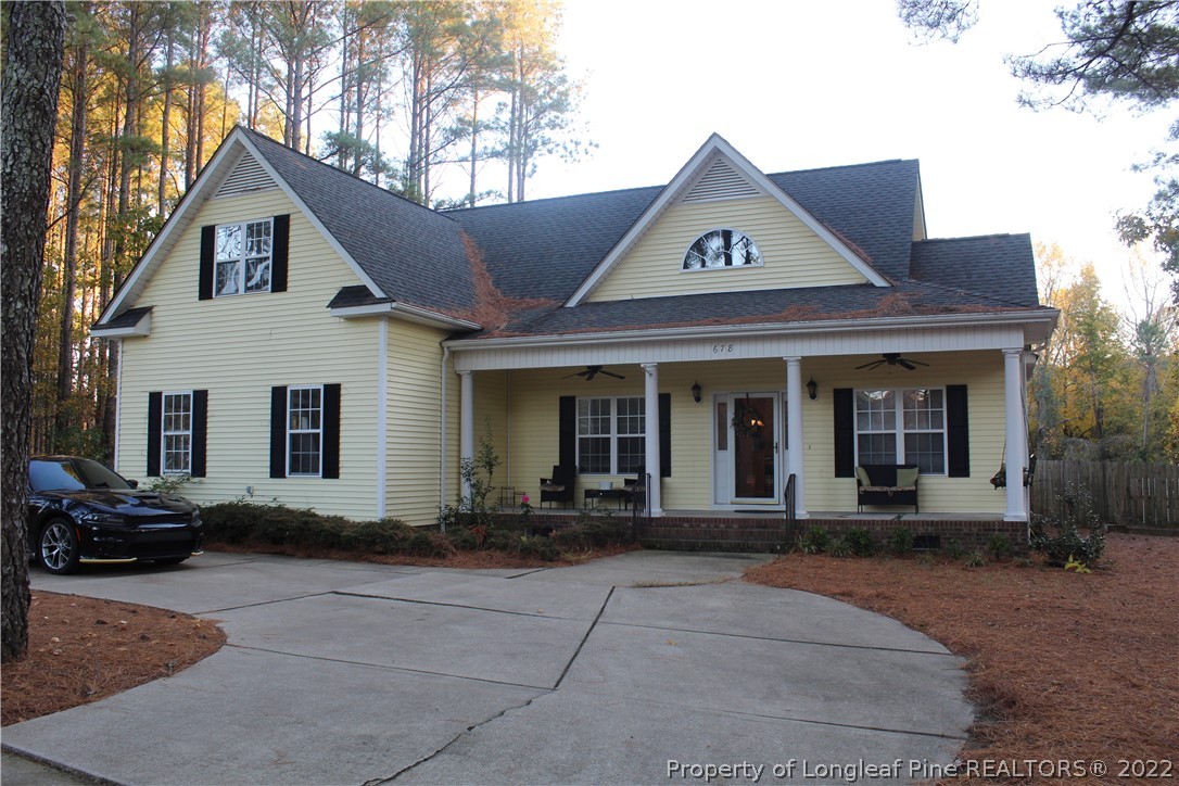 678 Tilghman Road Coats, NC 27521 - Photo 1 of 47 a front view of a house with garden