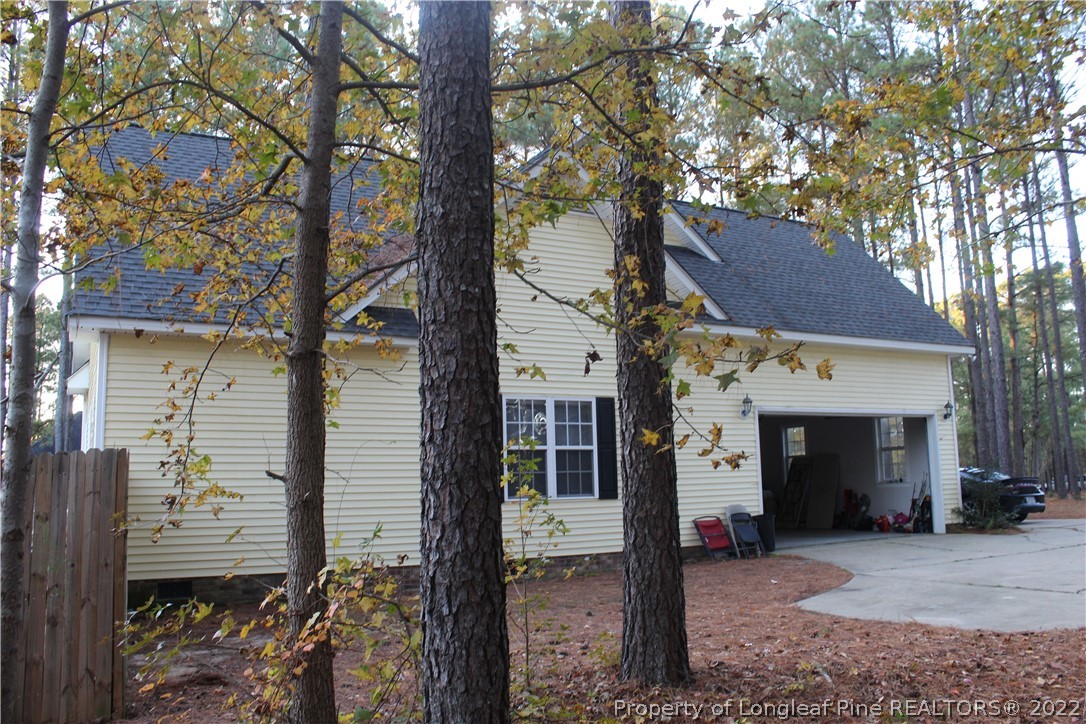 678 Tilghman Road Coats, NC 27521 - Photo 11 of 47 a front view of a house with a tree