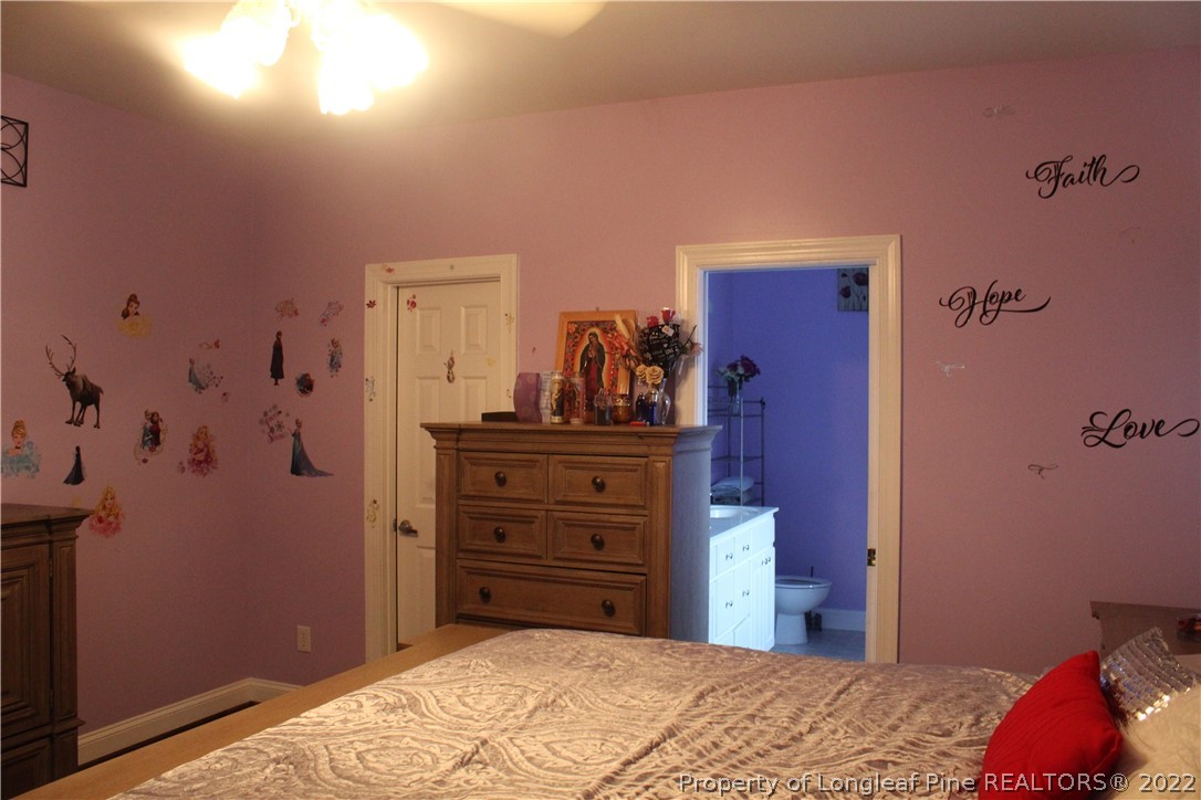 678 Tilghman Road Coats, NC 27521 - Photo 17 of 47 a bedroom with a bed and a dresser