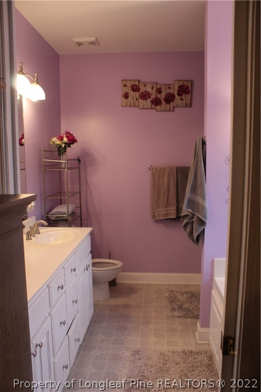 678 Tilghman Road Coats, NC 27521 - Photo 19 of 47 a bathroom with a sink a toilet and mirror