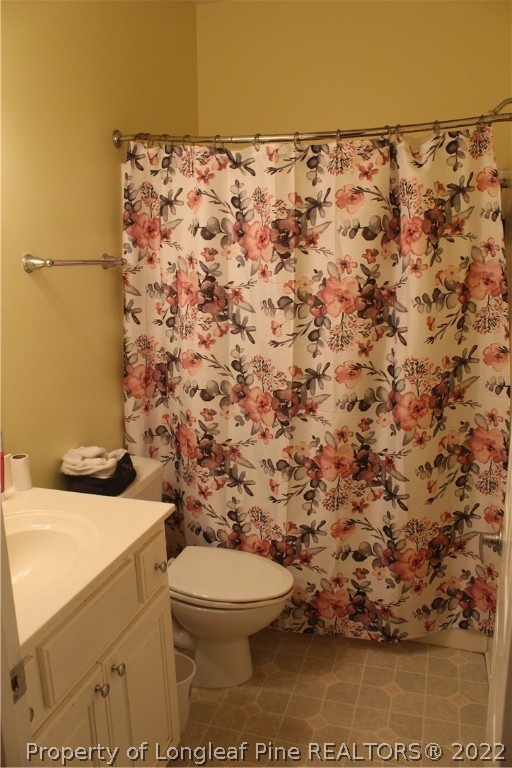 678 Tilghman Road Coats, NC 27521 - Photo 23 of 47 a bathroom with a toilet and a shower curtain