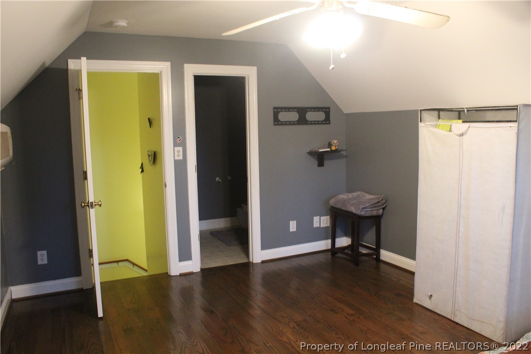 678 Tilghman Road Coats, NC 27521 - Photo 32 of 47 a view of a hallway with wooden floor and a bathroom