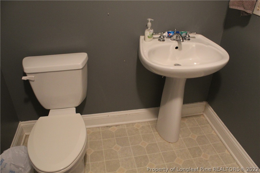 678 Tilghman Road Coats, NC 27521 - Photo 34 of 47 a bathroom with a toilet and a sink