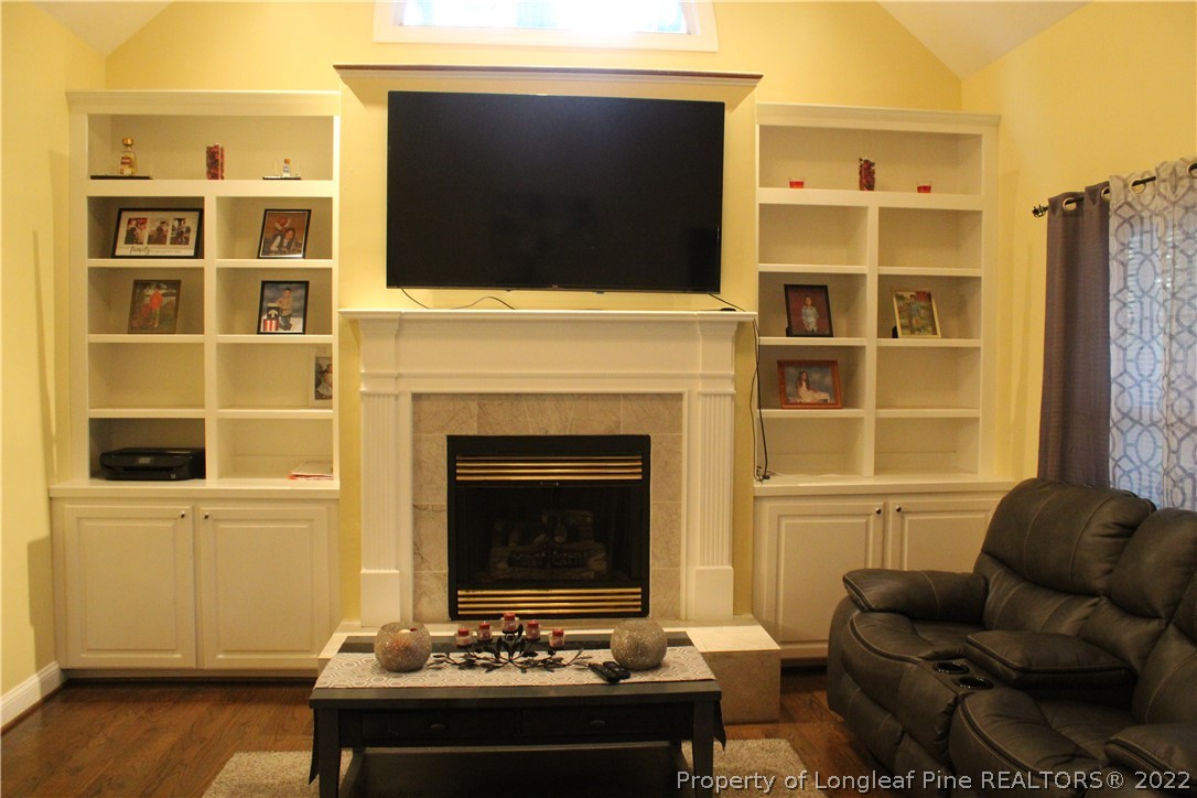 678 Tilghman Road Coats, NC 27521 - Photo 38 of 47 a living room with furniture windows and a fireplace