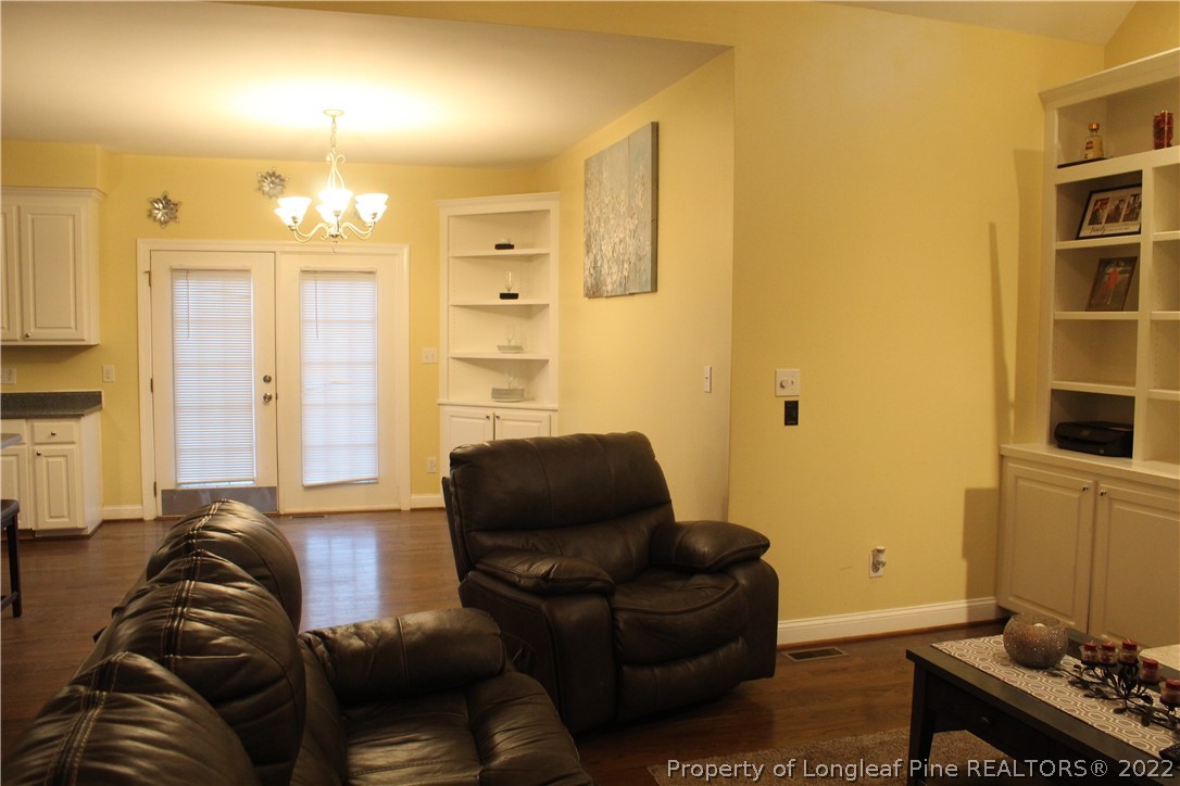 678 Tilghman Road Coats, NC 27521 - Photo 40 of 47 a living room with furniture and a chandelier