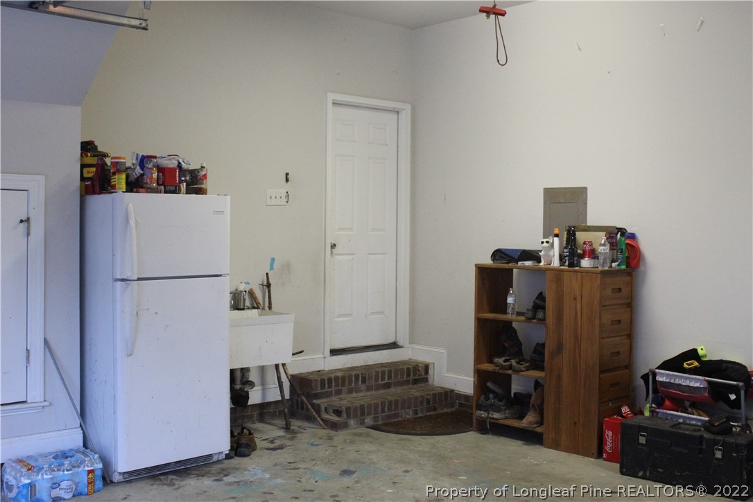678 Tilghman Road Coats, NC 27521 - Photo 45 of 47 a room with storage and utility