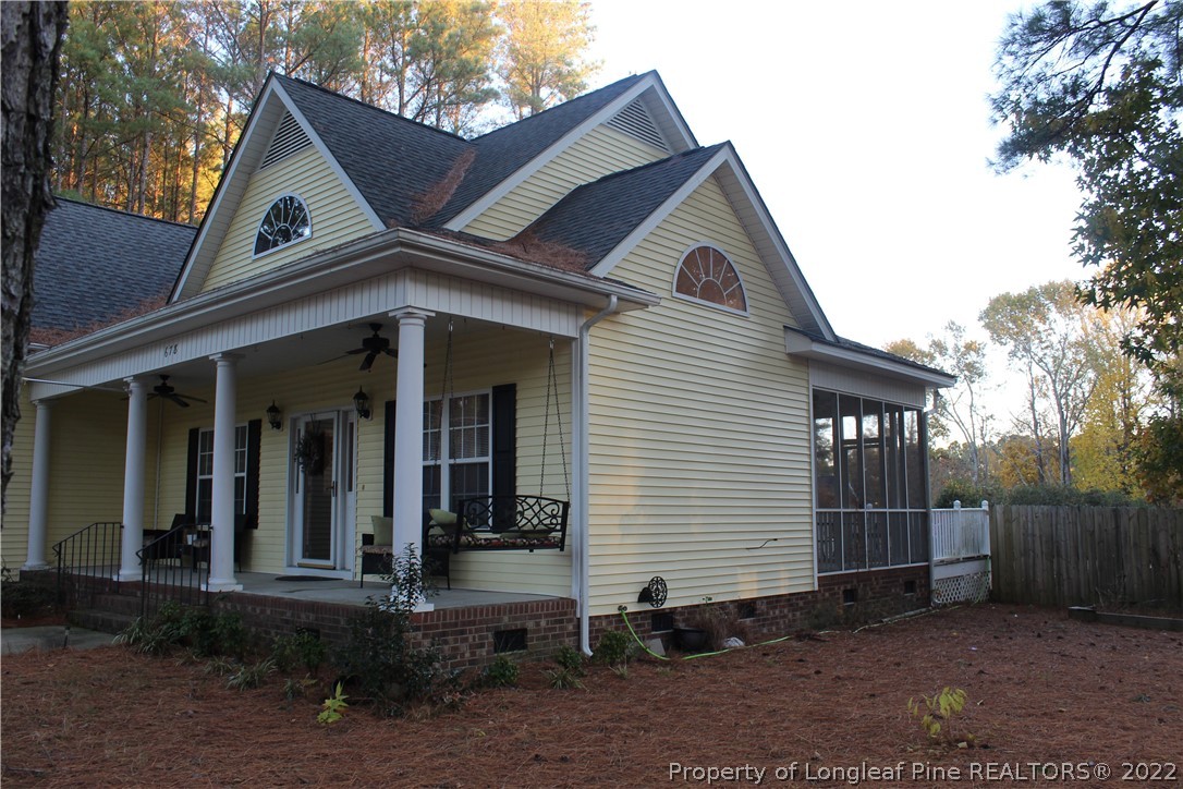 678 Tilghman Road Coats, NC 27521 - Photo 5 of 47 a front view of a house with garage