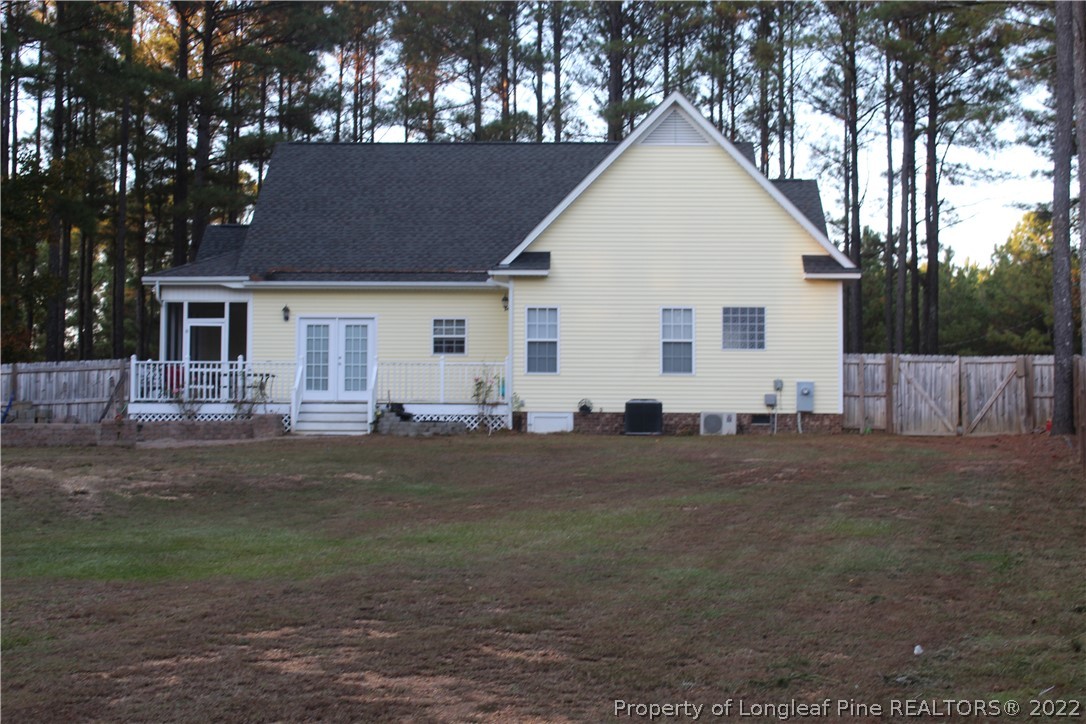 678 Tilghman Road Coats, NC 27521 - Photo 10 of 47 a view of a white house with a yard
