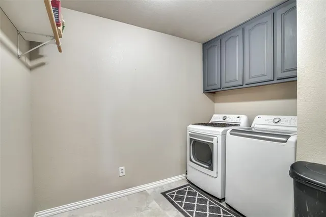 a view of a storage and utility room with washer and dryer