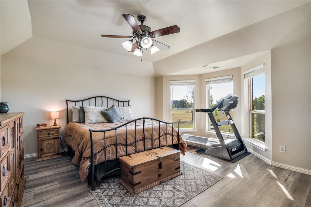 13064 Highland Court Forney, TX 75126 - Photo 17 of 25 a bedroom with furniture and a chandelier