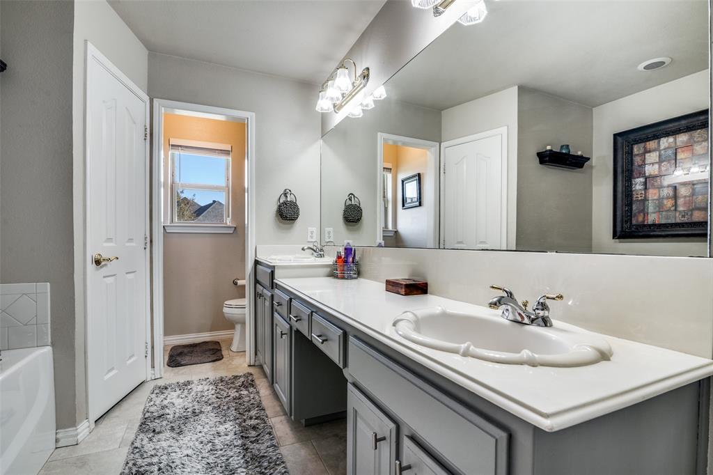 13064 Highland Court Forney, TX 75126 - Photo 18 of 25 a bathroom with a sink double vanity and a mirror