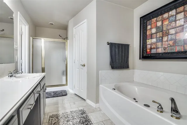 a bathroom with a tub sink and mirror