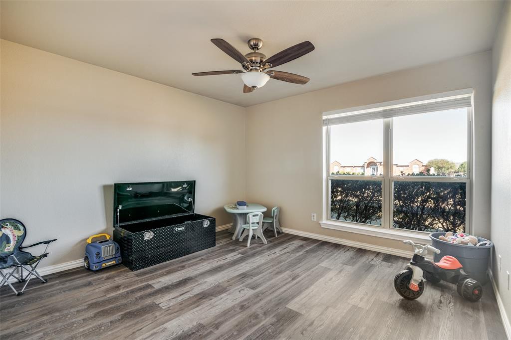 13064 Highland Court Forney, TX 75126 - Photo 20 of 25 a living room with furniture and a flat screen tv
