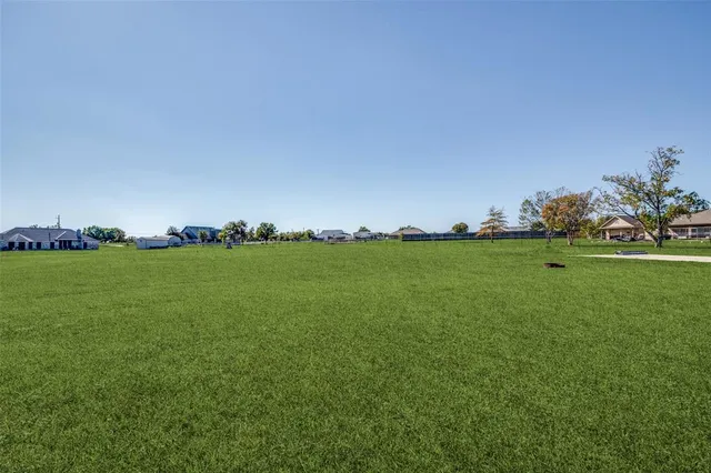 a view of yard with grass & house