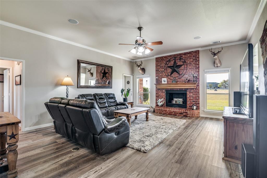 13064 Highland Court Forney, TX 75126 - Photo 6 of 25 a living room with furniture and a fireplace