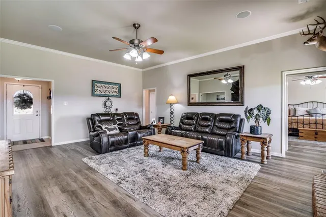 a living room with furniture and wooden floor