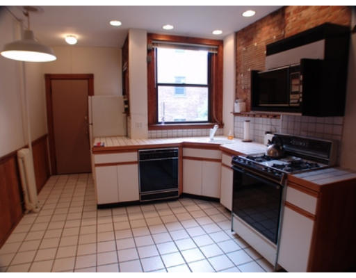 26 Beaufort Road, Unit 2 Boston, MA 02130 - Photo 5 of 8 a kitchen with a sink a stove and a microwave