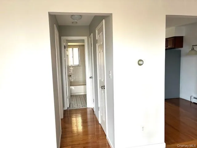a view of a hallway with wooden floor