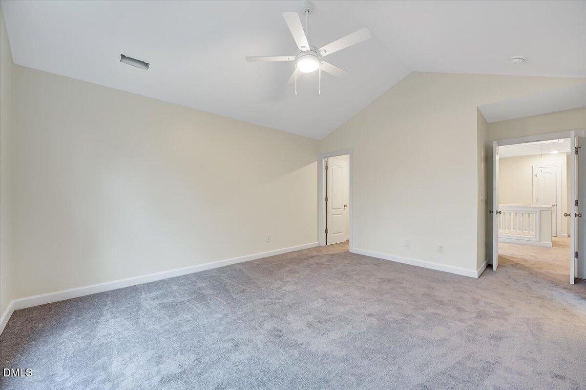 3218 Trassacks Drive Raleigh, NC 27610 - Photo 18 of 37 an empty room with a ceiling fan and a window