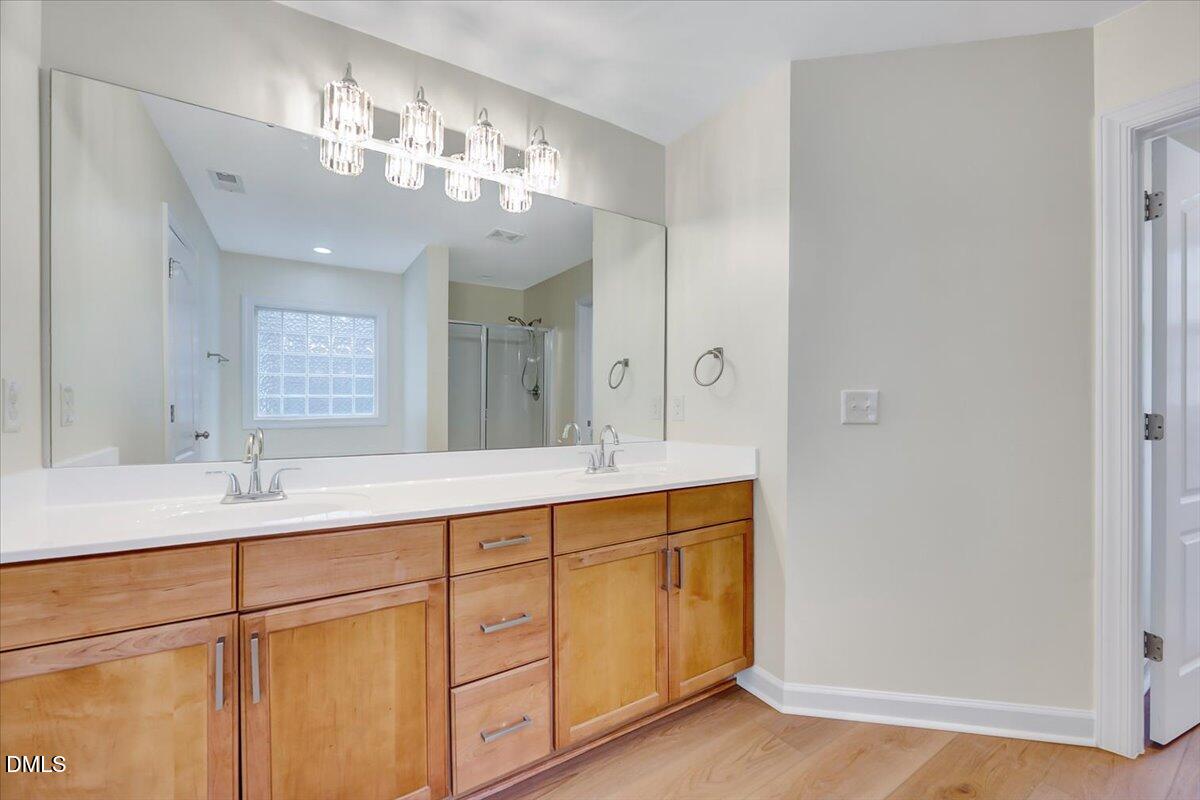 3218 Trassacks Drive Raleigh, NC 27610 - Photo 21 of 37 a bathroom with a double vanity sink and a mirror