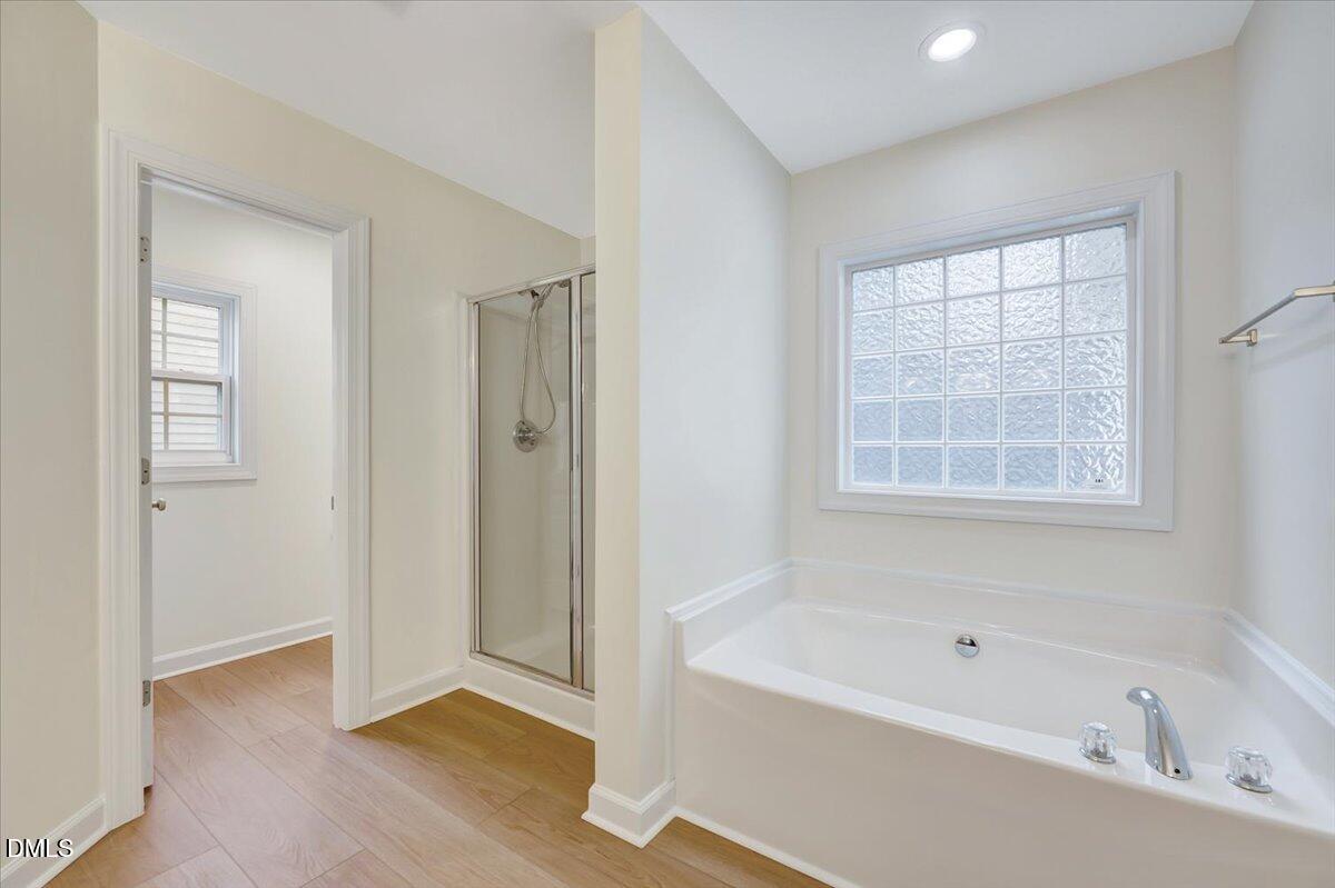 3218 Trassacks Drive Raleigh, NC 27610 - Photo 22 of 37 a bathroom with a bathtub and a shower