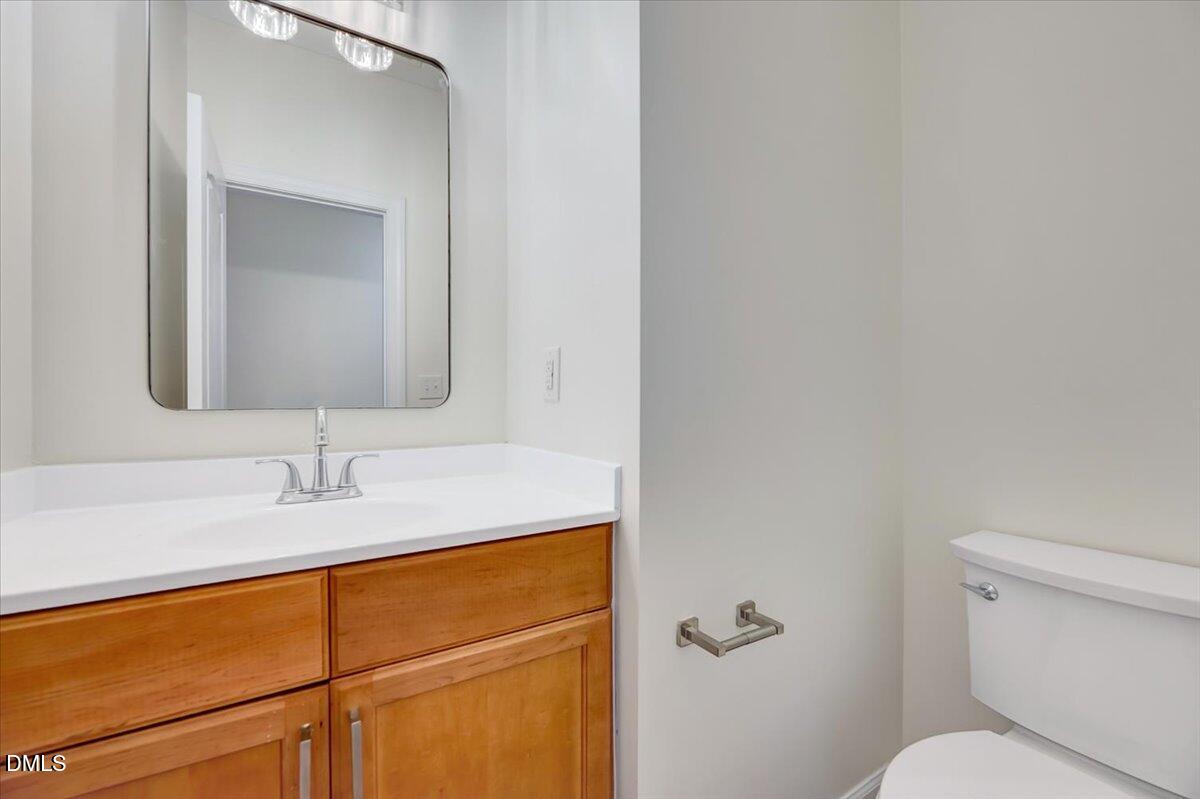 3218 Trassacks Drive Raleigh, NC 27610 - Photo 5 of 37 a bathroom with a toilet sink and mirror