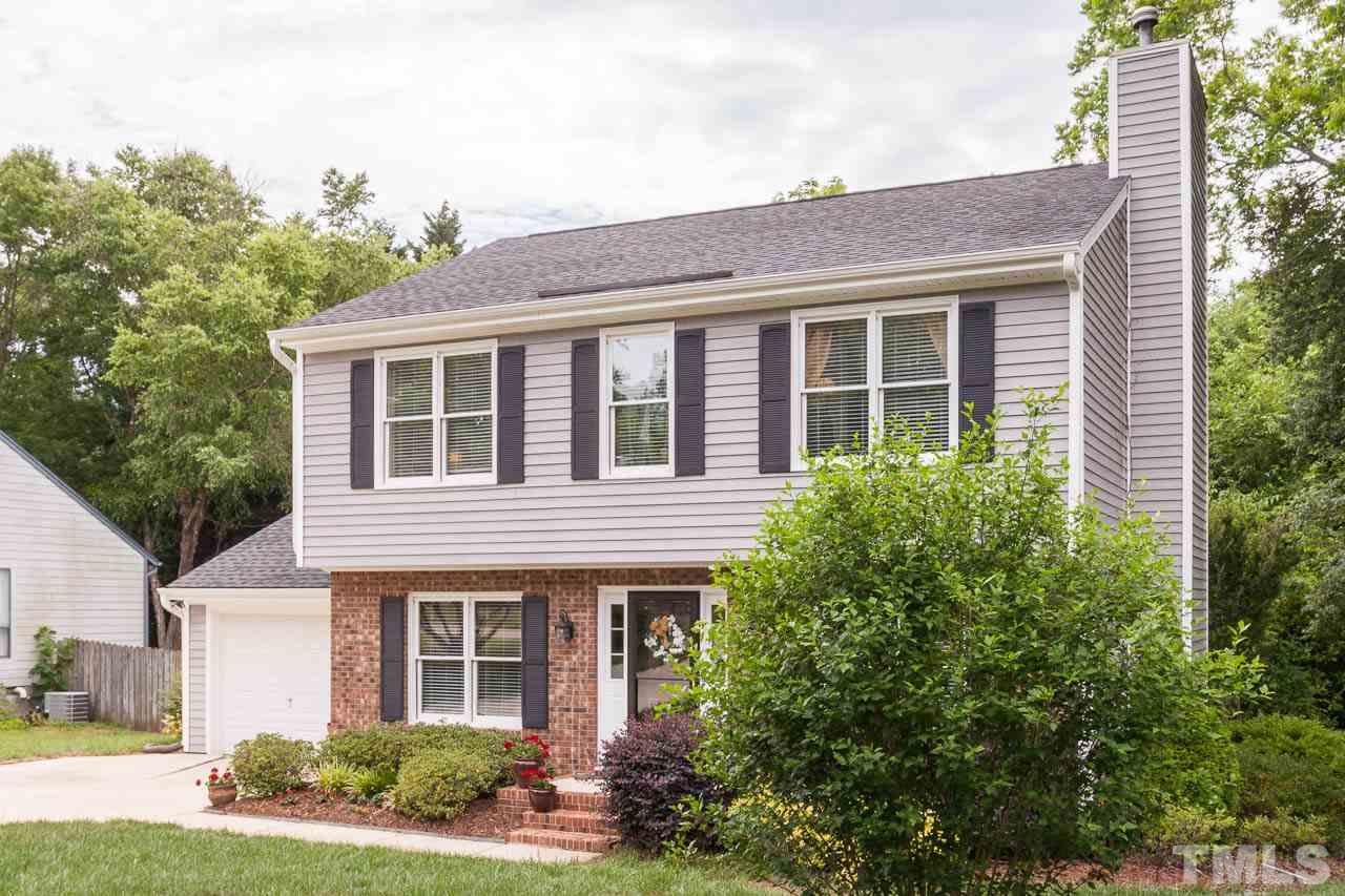 7317 Ridge Grove Court Raleigh, NC 27615 - Photo 2 of 25 a front view of a house with a yard and potted plants