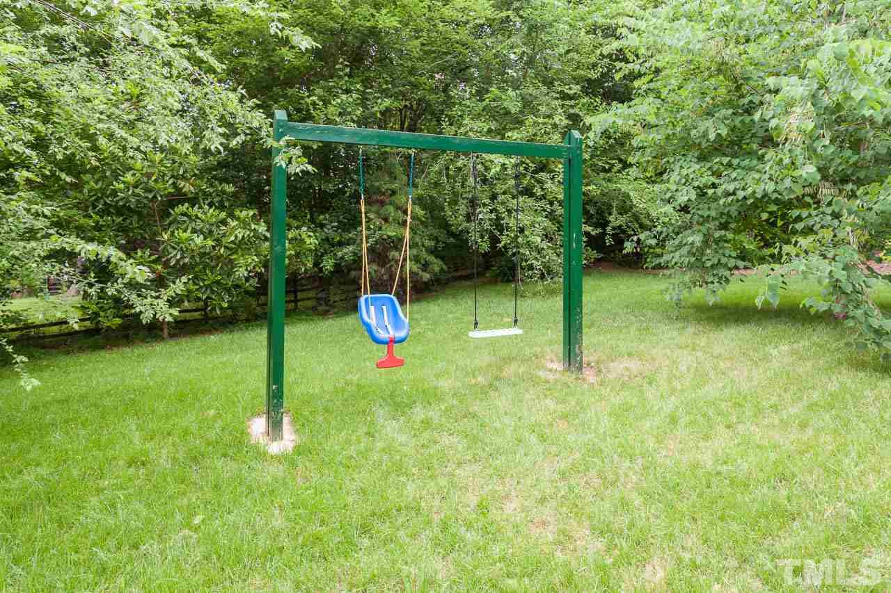 7317 Ridge Grove Court Raleigh, NC 27615 - Photo 15 of 25 a view of a backyard with a slide
