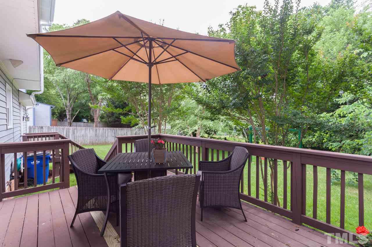 7317 Ridge Grove Court Raleigh, NC 27615 - Photo 16 of 25 a view of deck with furniture and umbrella