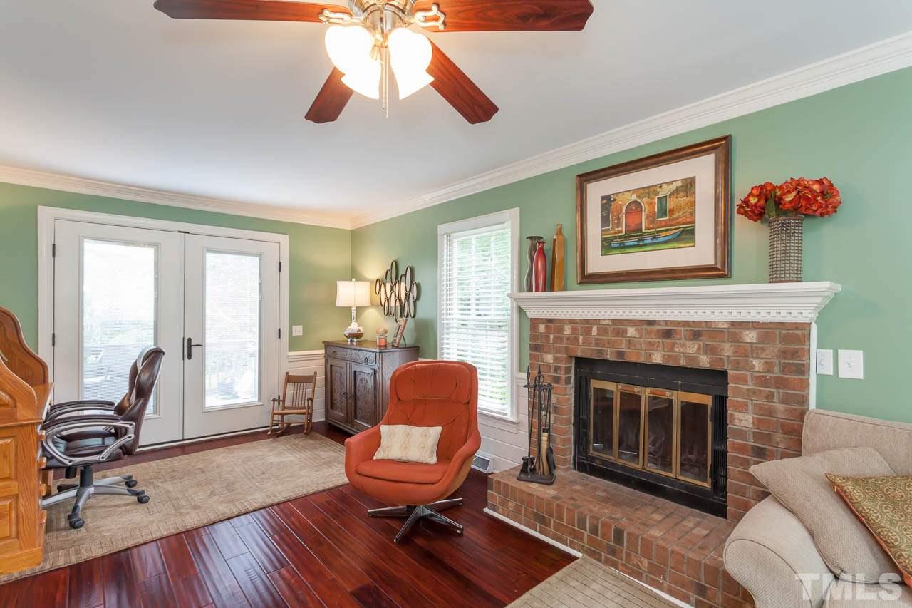 7317 Ridge Grove Court Raleigh, NC 27615 - Photo 20 of 25 a living room with furniture and a fireplace
