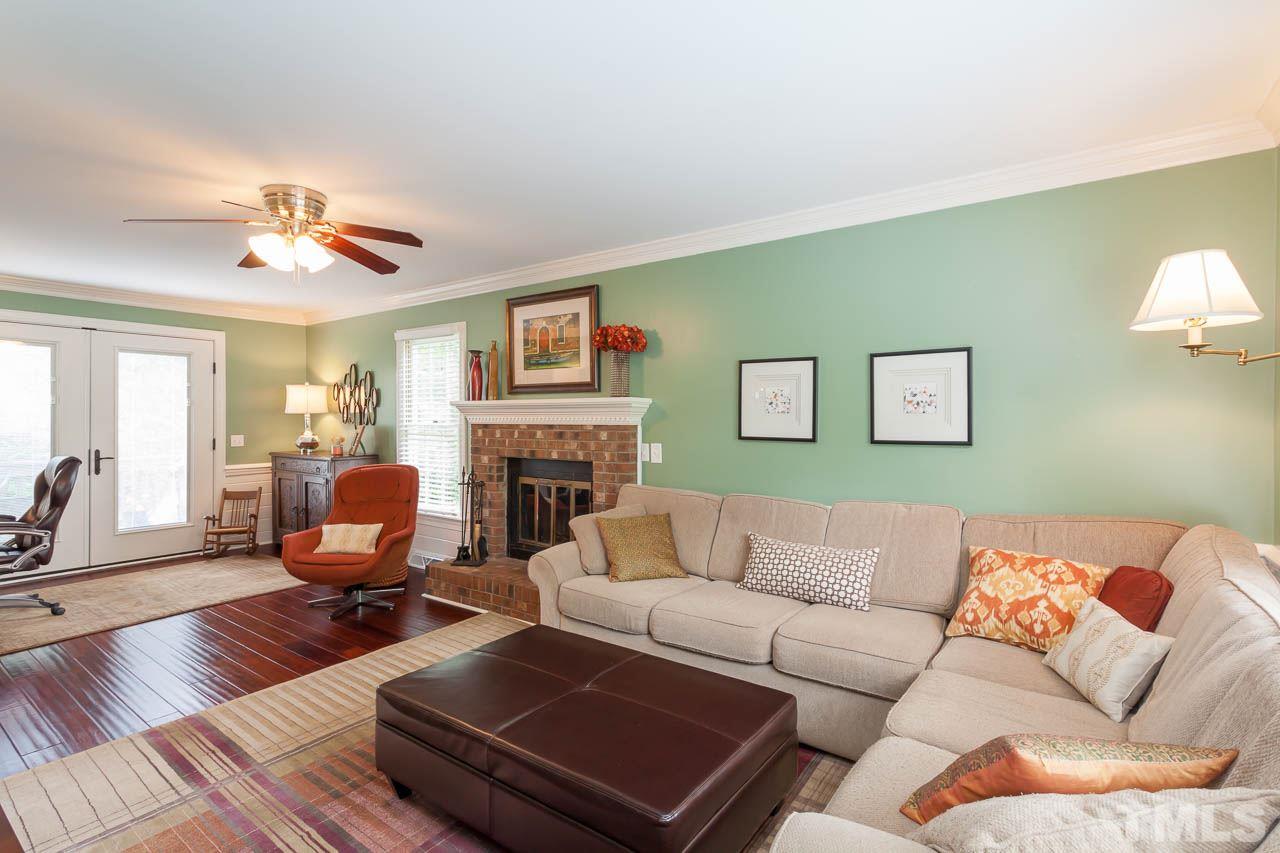 7317 Ridge Grove Court Raleigh, NC 27615 - Photo 21 of 25 a living room with furniture fireplace and a large window