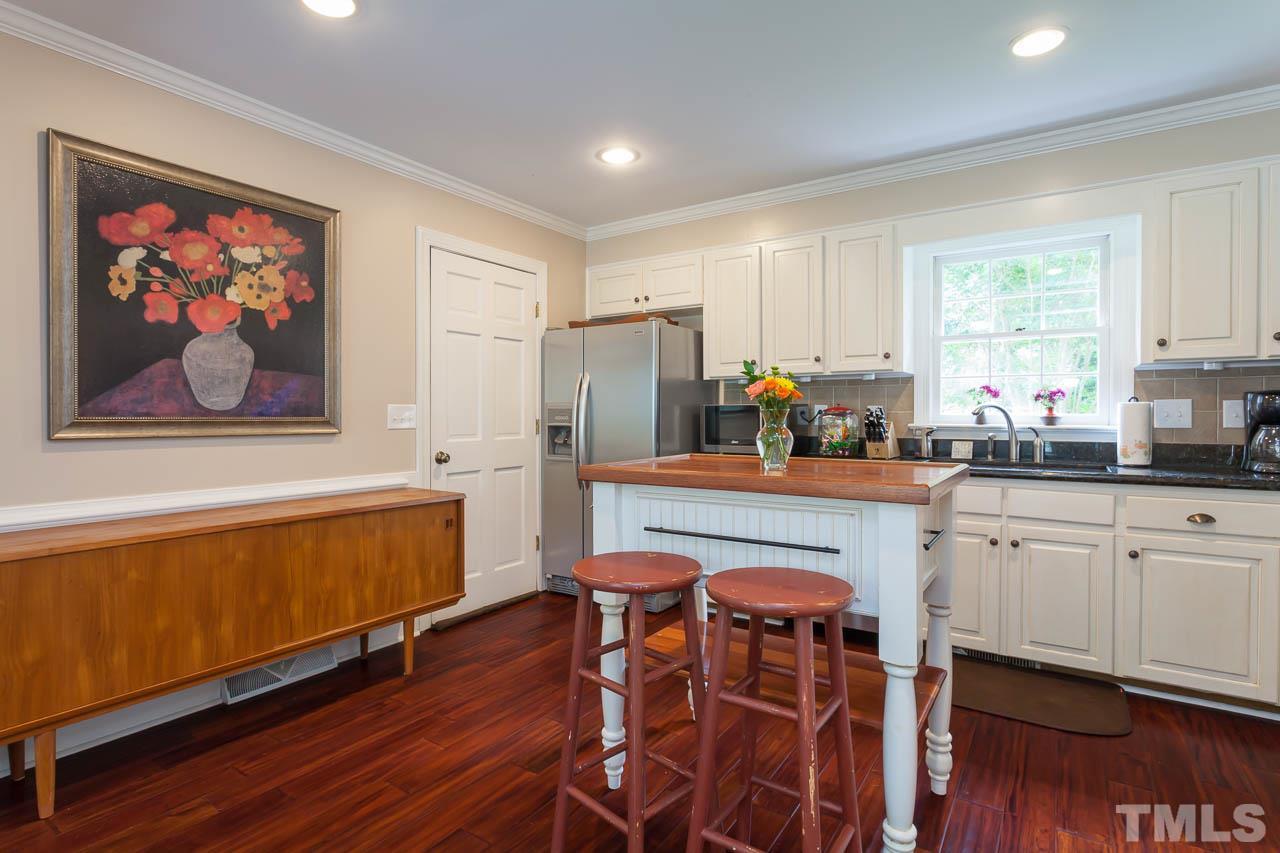 7317 Ridge Grove Court Raleigh, NC 27615 - Photo 23 of 25 a kitchen with stainless steel appliances granite countertop a refrigerator and a stove top oven