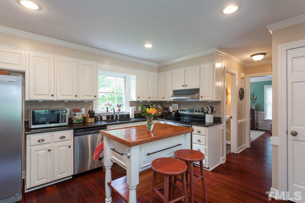 7317 Ridge Grove Court Raleigh, NC 27615 - Photo 24 of 25 a kitchen with granite countertop a counter top space appliances and cabinets
