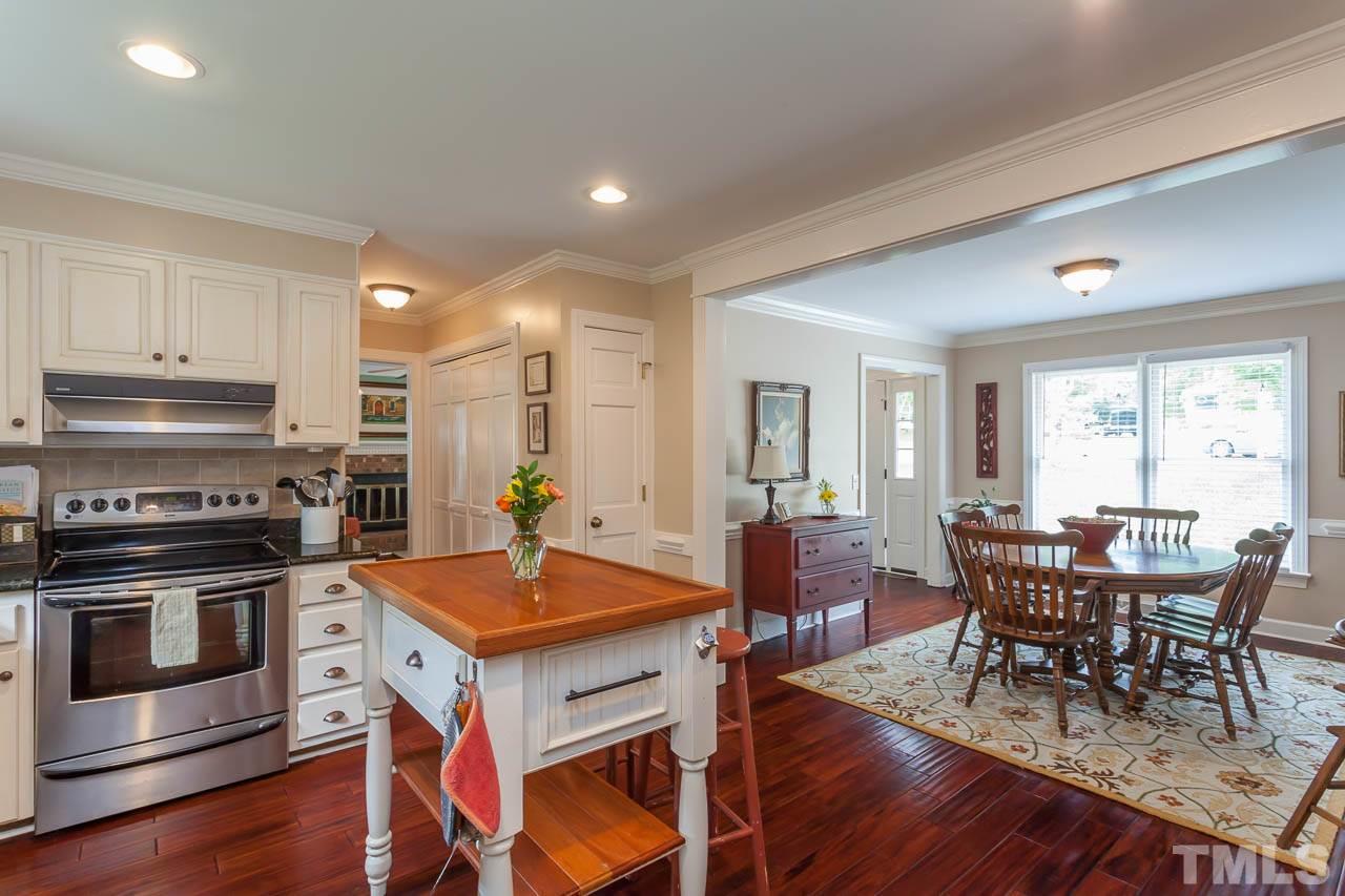 7317 Ridge Grove Court Raleigh, NC 27615 - Photo 25 of 25 a view of a dining room with furniture window and wooden floor