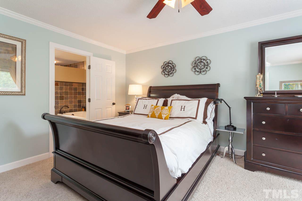 7317 Ridge Grove Court Raleigh, NC 27615 - Photo 6 of 25 a bedroom with a bed and a dresser