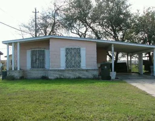 a view of a yard with a house and a large tree