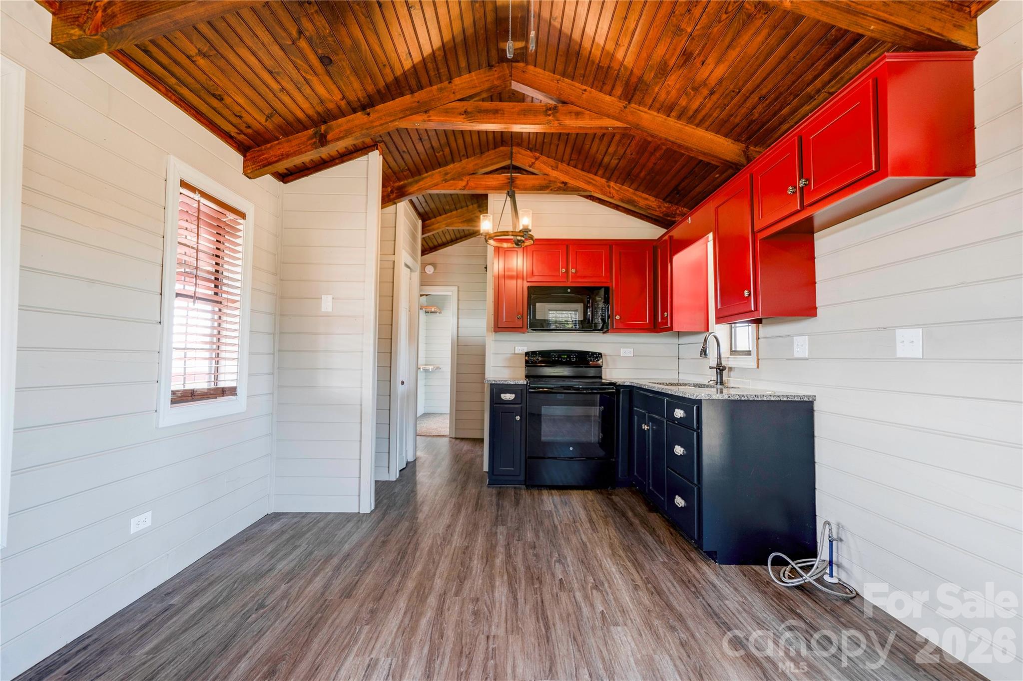 101 Hull Road Casar, NC 28020 - Photo 10 of 25 a kitchen with stainless steel appliances granite countertop a refrigerator a sink dishwasher a stove and white countertops with wooden floor
