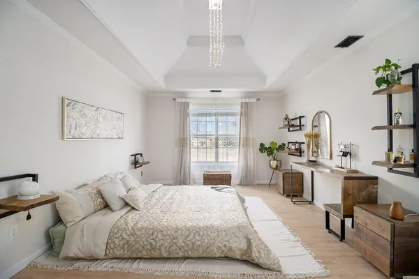 a bedroom with a large bed and a desk