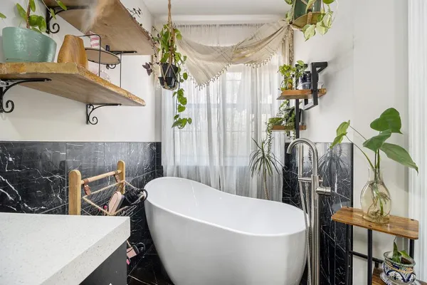 a white bath tub sitting next to a white house