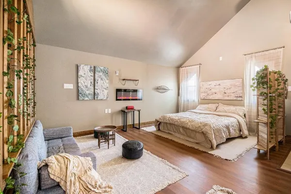 a bedroom with a bed and couch