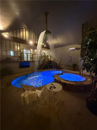 a view of a swimming pool with an outdoor seating