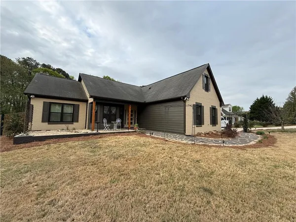 a view of a house with a yard and garage