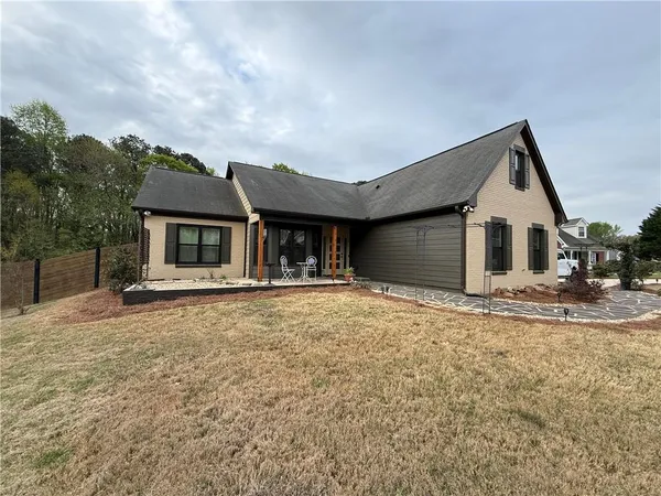 a front view of a house with a garden